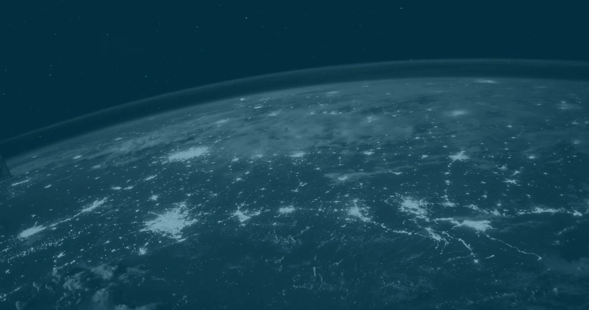Earth viewed from space, illuminated by city lights, showcasing a vibrant and interconnected planet at night